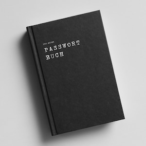 May include: A black hardback book with the title "PASSWORT BUCH" printed in white on the front cover.