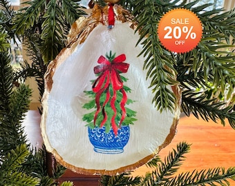 Blue and white chinoiserie oyster shell ornament with gilded gold edges and red ribbon hanging decoration