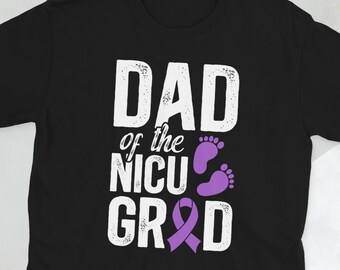 May include: Black t-shirt with the text "DAD of the NICU GRAD" in white, with purple baby footprints and a purple awareness ribbon. The shirt is a short-sleeved crew neck.
