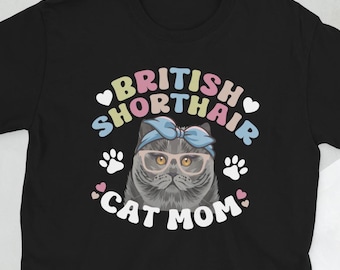 May include: Black t-shirt with a graphic of a British Shorthair cat wearing glasses and a headband. The text "British Shorthair Cat Mom" is printed on the shirt.