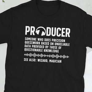 May include: Black t-shirt with white text that reads "PRODUCER" and a definition of the word. The definition includes the text "SEE ALSO: WIZARD, MAGICIAN".