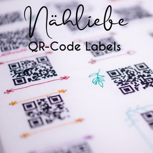 May include: A close-up of several white labels with black and white QR codes. The labels are decorated with colorful embroidery and the text "Nähliebe QR-Code Labels" is visible at the top of the image.