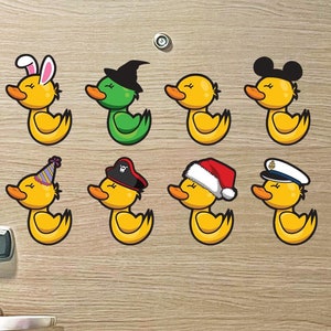 May include: Eight yellow rubber duckies with different hats on a wooden door. The hats include a bunny, witch, Santa, pirate, party hat, Mickey Mouse ears, and a navy captain's hat.