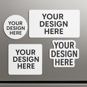 May include: A collection of white magnets in various shapes: a circle, a rectangle, a square, and a custom shape. Each magnet features the text "YOUR DESIGN HERE" in black, offering a customizable design space for personalization.