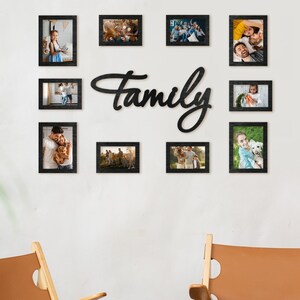 May include: A wall display with a black 'Family' sign and framed photos. Two wooden chairs with tan leather seats and a small wooden side table are in front of the wall. The chairs have a light wood frame.