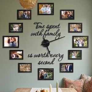 May include: A wall-mounted clock featuring black metal hands and the black script text "Time spent with family is worth every second" arranged around the center, surrounded by ten rectangular black photo frames displaying various family portraits.