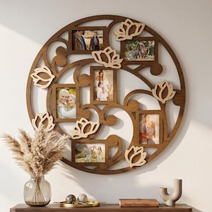 May include: A circular dark brown wooden wall frame featuring five rectangular photo slots integrated into a decorative cutout design with six light-colored flower-shaped accents. The frame displays various family photographs.