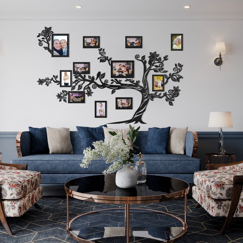 May include: A black metal family tree wall decor with multiple photo frames. The frames are arranged in a tree shape and feature photos of different people. The decor is mounted on a white wall in a living room setting.