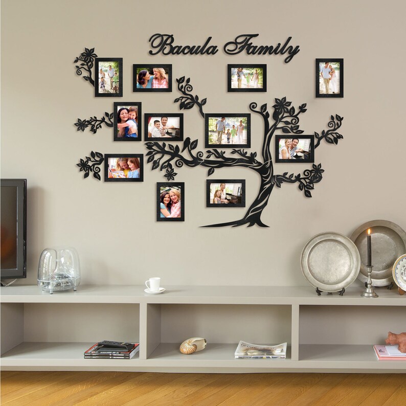May include: Black metal family tree wall decor with 13 photo frames. The frames are arranged in a tree shape with the words "Bacula Family" at the top.
