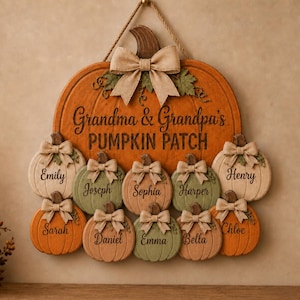 May include: A large orange wooden pumpkin sign with a jute rope hanger and a burlap bow. The text reads Grandma & Grandpa's PUMPKIN PATCH. Ten smaller wooden pumpkins in orange, green, and cream are attached, each featuring a name and a burlap bow.
