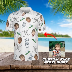 May include: White golf-themed polo shirt with a repeating pattern of golf clubs, golf balls, and a person's face. The text "Best Dad by par" is repeated throughout the pattern.