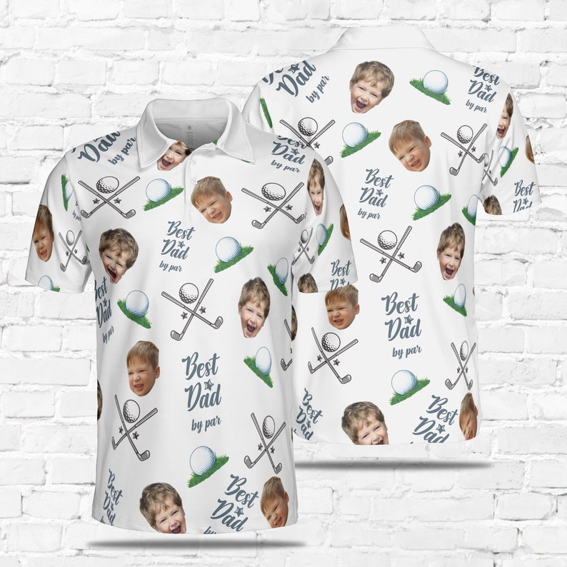 May include: White golf-themed polo shirt with a repeating pattern of golf clubs, golf balls, and a child's face. The text "Best Dad by par" is repeated throughout the pattern.