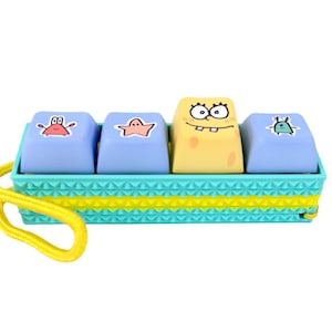 Bob Picky Clicky™ Clicking fidget with textured sides.  Easy travel fidget toy with sensory feedback design.