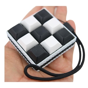 9 KEYS Picky Clicky™ Clicking fidget with textured sides  Easy travel fidget toy with sensory feedback design.