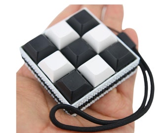 9 KEYS Picky Clicky™ Clicking fidget with textured sides  Easy travel fidget toy with sensory feedback design.