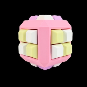May include: A colourful geometric puzzle toy. The cube-shaped toy is predominantly pink, with white, yellow, and purple accents. It features rotating sections with rectangular blocks. The background is black.