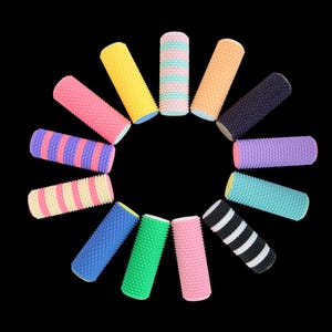 May include: A collection of colorful, cylindrical foam rollers arranged in a circle against a black background. The rollers vary in color, including pink, yellow, blue, green, and striped patterns. Each roller has a textured surface.