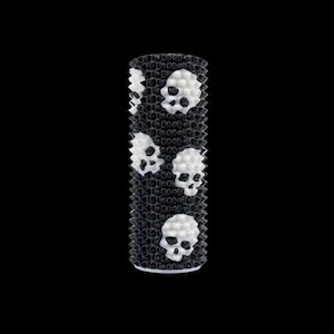 May include: A cylindrical black and white patterned object with a textured surface. The design features white skull shapes against a black background. The object is set against a solid black backdrop.