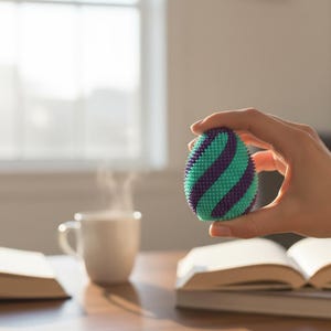 May include: A set of three ceramic mugs with a speckled, cream-colored glaze. Each mug features a different hand-painted floral design in shades of blue, green, and yellow. The mugs have a simple, rounded shape and a comfortable handle.