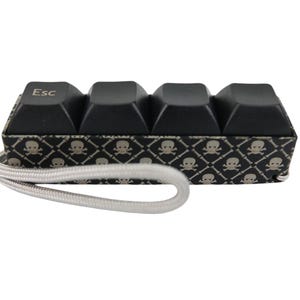 ESC Skull Picky Clicky™ Clicking fidget with smooth skull sides. Easy travel fidget toy with sensory feedback design.