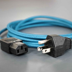 May include: A blue power cord with a black US plug on one end and a black IEC connector on the other end.