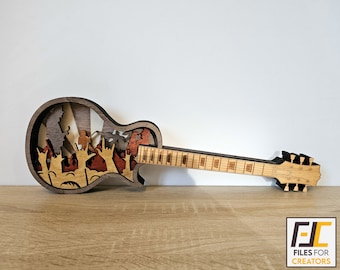 May include: A wooden cutout of a guitar with a crowd of people in the body of the guitar. The guitar is brown and the crowd is in shades of red, orange, and yellow.