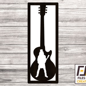 May include: Black and white silhouette of a person playing a guitar. The silhouette is inside a black frame.