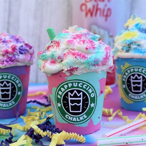 May include: Three colorful DIY Frappuccino cups with whipped cream and sprinkles. The cups are decorated with a green, white, and black logo that says "Frappuccino Chalks".