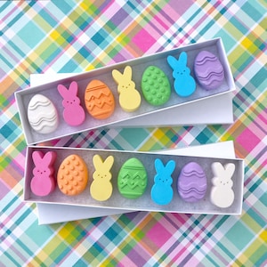 May include: A set of three ceramic mugs with a speckled, matte finish. Each mug features a different color: light blue, cream, and gray. The mugs have a simple, modern design and a comfortable handle.