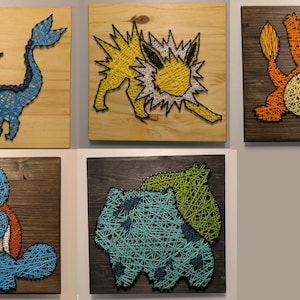 May include: Five string art pieces depicting different Pokemon characters. The characters are: Vaporeon, Jolteon, Flareon, Squirtle, and Bulbasaur. Each piece is framed on a wooden board.