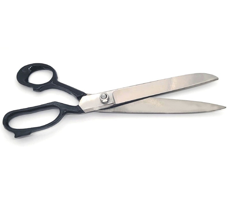 May include: Scissors with black handles and silver blades. The scissors are open and ready for cutting.