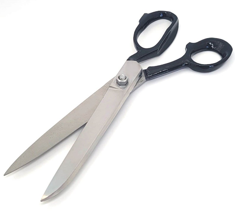 May include: A pair of large, black-handled scissors with silver blades. The scissors are open and the blades are sharp.