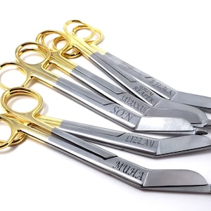 May include: Set of six gold-handled surgical scissors with personalized names engraved on the blades: B.Flack, Grim Reaper, Savannah, Son, Lizzy, and Mujca.