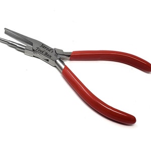 May include: A pair of metal pliers with red handles. The pliers have a silver finish and the text "Jared's Tool Box" is printed on the side. The tool is designed for bending and shaping wire.