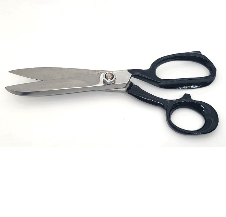 May include: Black handled shears with silver blades. The shears have a small screw in the centre of the blades.