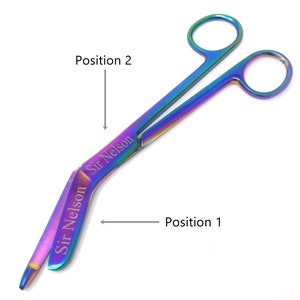 May include: Rainbow-coloured surgical scissors with a curved blade. The scissors are engraved with the text "Sir Nelson". The image shows the scissors in two positions, labelled "Position 1" and "Position 2".