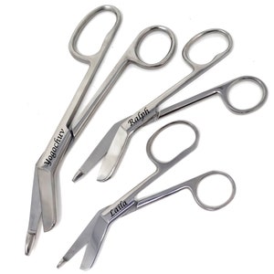 May include: Four stainless steel bandage scissors with the names "Yogochav", "Ralph", "Laila" engraved on them.