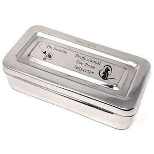 May include: Stainless steel medical supply box with a personalized inscription that reads "Dr. Roxette Professional Toe Bean Inspector" with a stethoscope and paw print graphic.