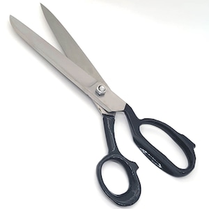 May include: A pair of large, silver fabric shears with black handles. The blades are sharp and the handles are comfortable to grip.