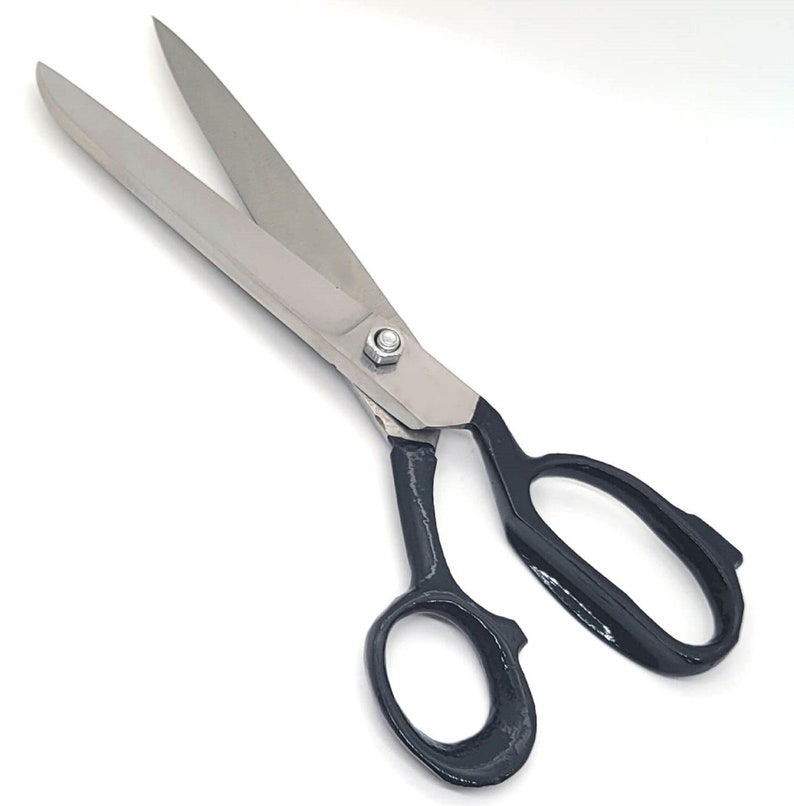 May include: A pair of large, silver fabric shears with black handles. The blades are sharp and the handles are comfortable to grip.