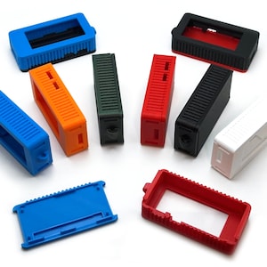 May include: Assortment of 10 plastic cases in various colors, including red, orange, blue, green, black, and white. The cases are designed to hold small electronic devices.