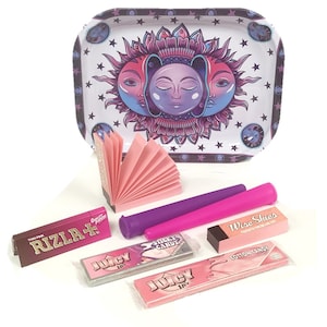 May include: A pink and purple rolling tray featuring a sun and moon design. The tray is surrounded by pink rolling papers, a pink and purple rolling tube, and a pack of Juicy Jay's rolling papers. The tray also includes a pack of Rizla+ rolling papers, a pack of Sticky Candy rolling papers, a pack of Cotton Candy rolling papers, and a pack of Wise Skies rolling papers.