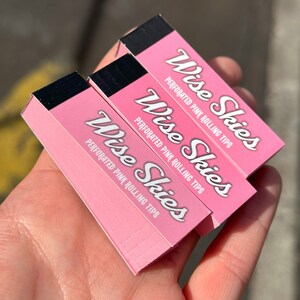 May include: Three pink boxes of Wise Skies perforated pink rolling tips.