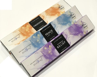 May include: Three boxes of incense sticks with different scents: Freedom, Peace and Joy, and Stress Relief. Each box features a watercolor-style background with a gold accent and the Wise Skies logo.