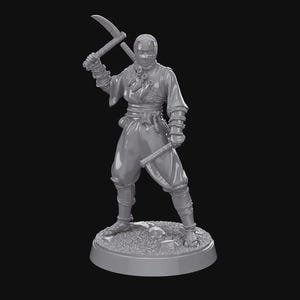 May include: A gray figurine of a ninja, posed with two curved blades. The ninja is wearing a mask and traditional clothing, standing on a circular base with a textured surface. The figure is detailed and appears to be a collectible item.
