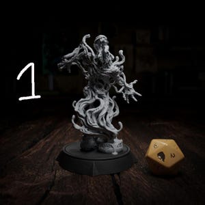 May include: A detailed, gray miniature figure of a monster with a textured, swirling body and outstretched arms. The figure stands on a black base, next to a yellow, multi-sided die with black markings. The number "1" is written in white.