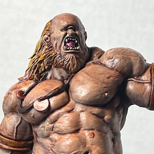 May include: A detailed, hand-painted figurine of a muscular, enraged humanoid creature. The figure has a bald head, a snarling expression, and long, flowing yellow hair. It wears brown leather straps and has a detailed, textured skin tone.