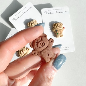 May include: Three brown bear-shaped cookie pins with colourful sprinkles. The pins are handmade and are displayed on white cards with the text "Handmade Jewellery by Benkendreams" and the website address "benkendreams.com.au".