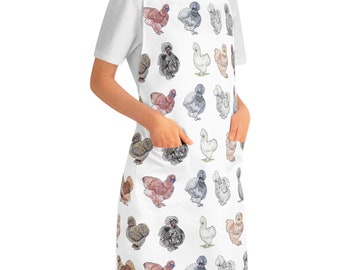 May include: White apron featuring a pattern of colourful chickens. The chickens are all different breeds and colours, and they are arranged in a random pattern. The apron has two pockets on the front.