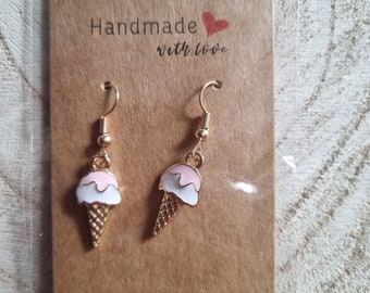 May include: Gold tone ice cream cone dangle earrings with pink and white enamel. The earrings are packaged on a brown card with the text "Handmade with love".
